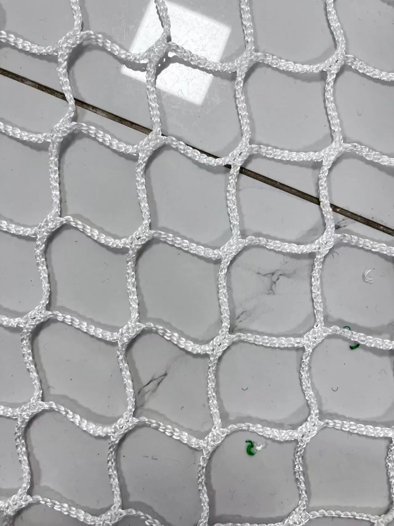 White knotless polyester ball stop netting, 45 mm mesh, factory close-up
