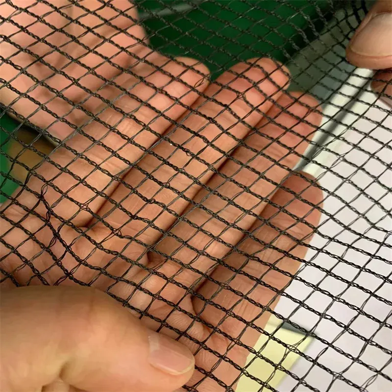 Black fine knotless netting checked by hand in the workshop