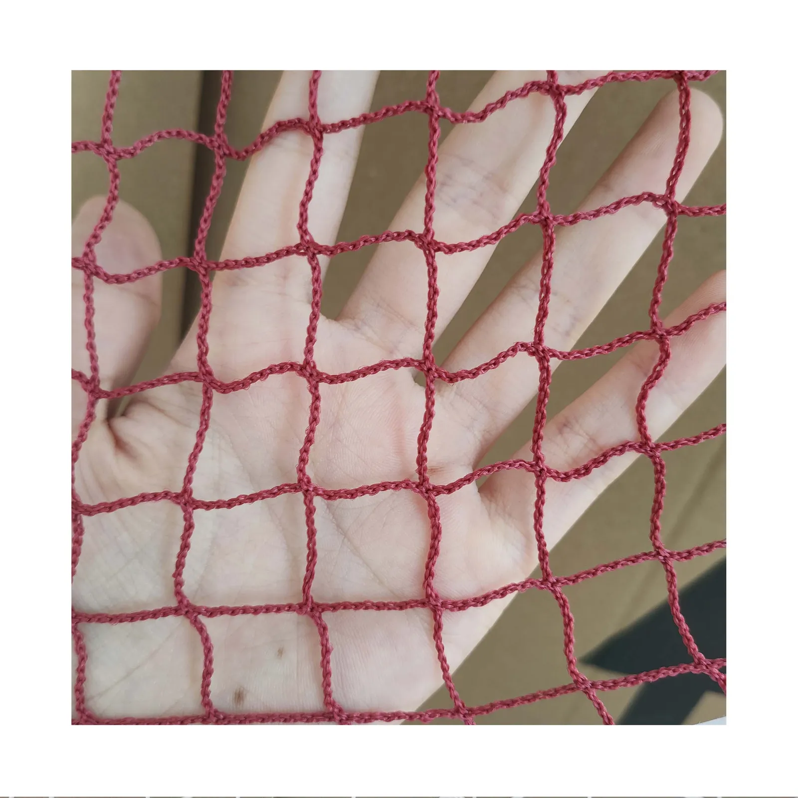 Golf barrier netting, 20 mm mesh, 1 mm twine, factory sample close-up on hand