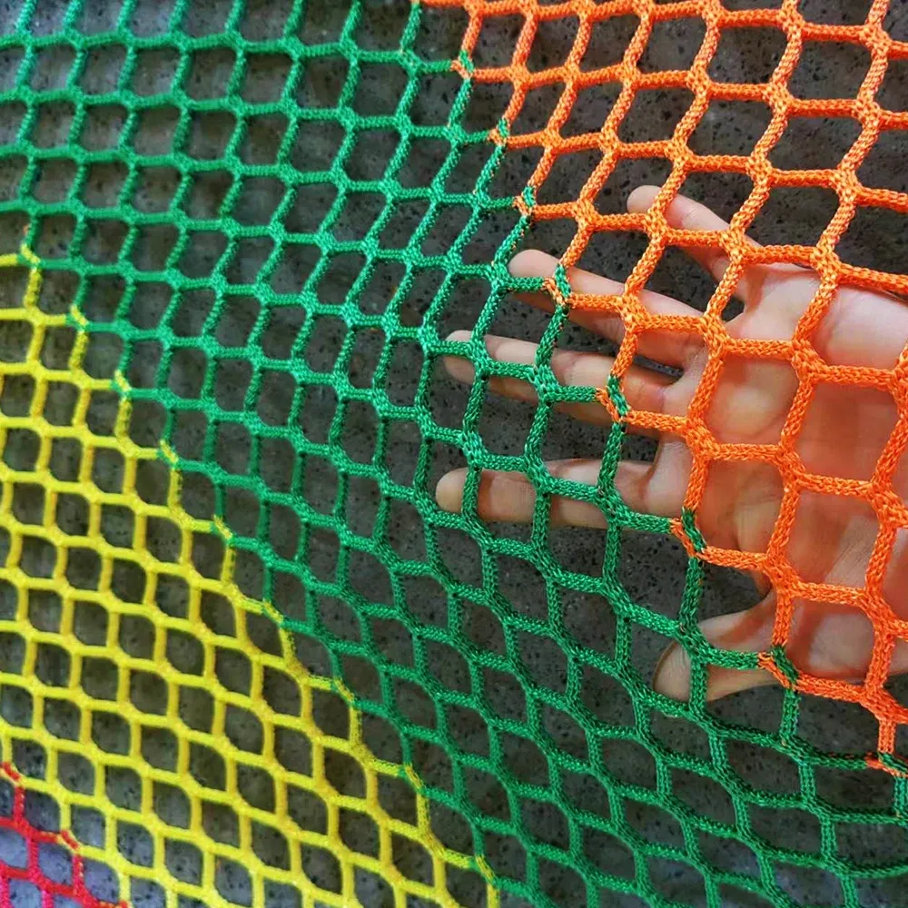 Multicolour knotless netting held against stone, supplier product photo